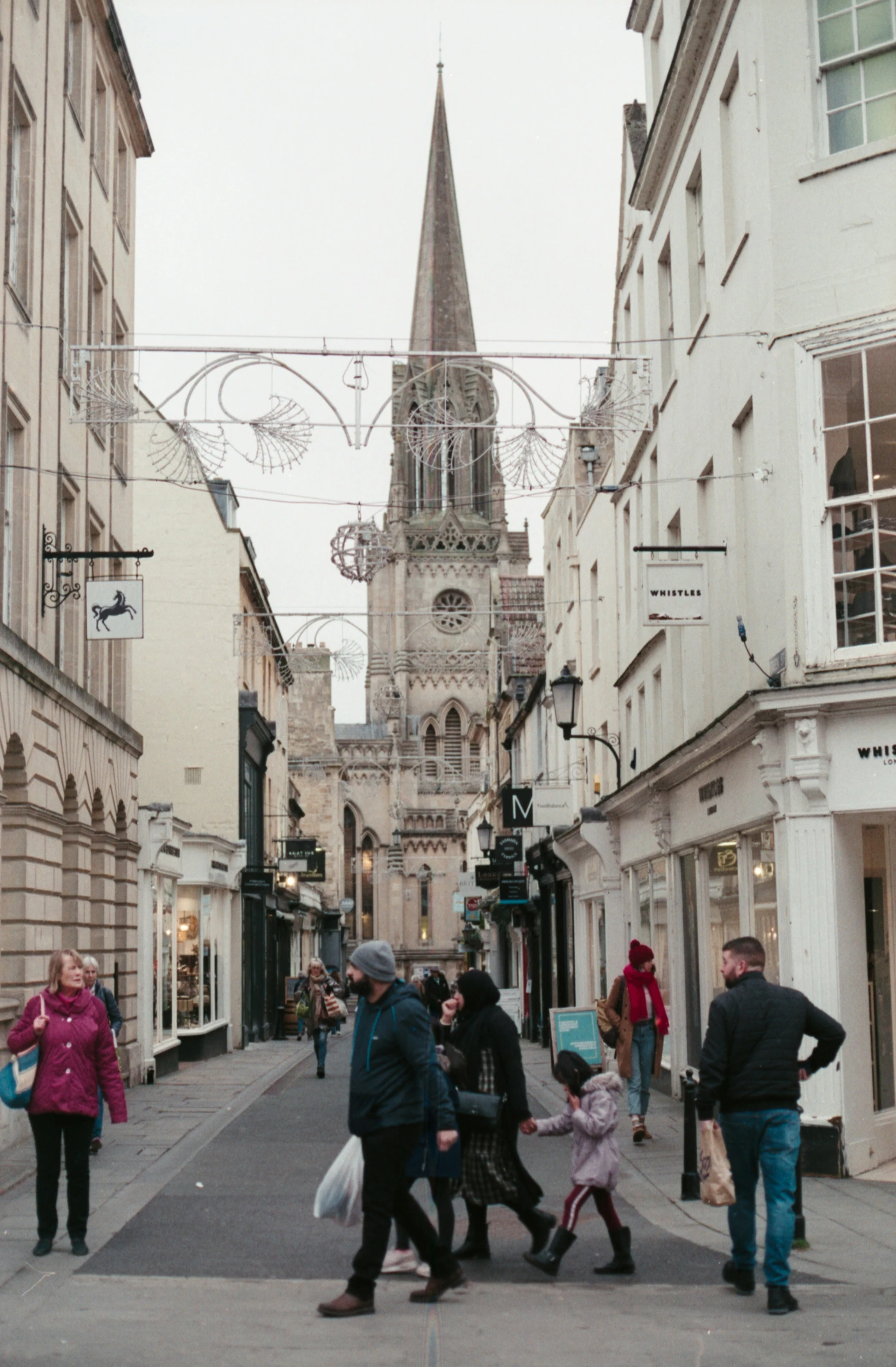 a street filled with pedestrians and a bunch of buildings