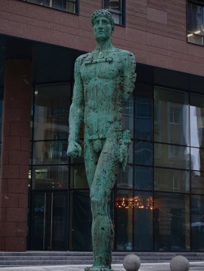 an artisticly crafted statue outside of a building