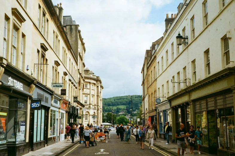 a group of people walking in a row in between two buildings