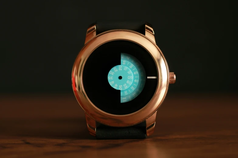 a watch with a blue light sitting on a table
