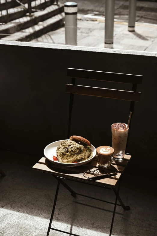 an empty chair on a table with food on it