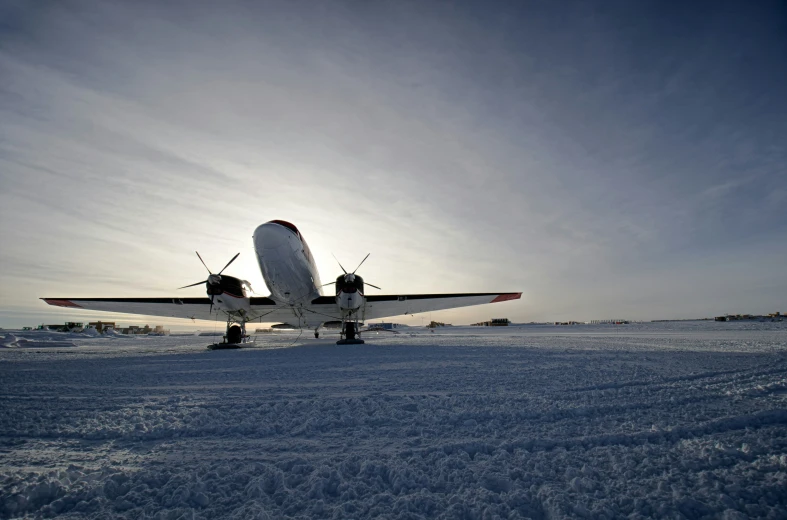 a small plane in the snow, heading to take off