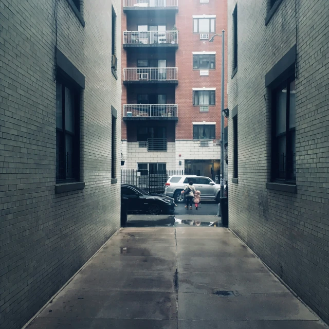 a narrow alley way surrounded by brick buildings