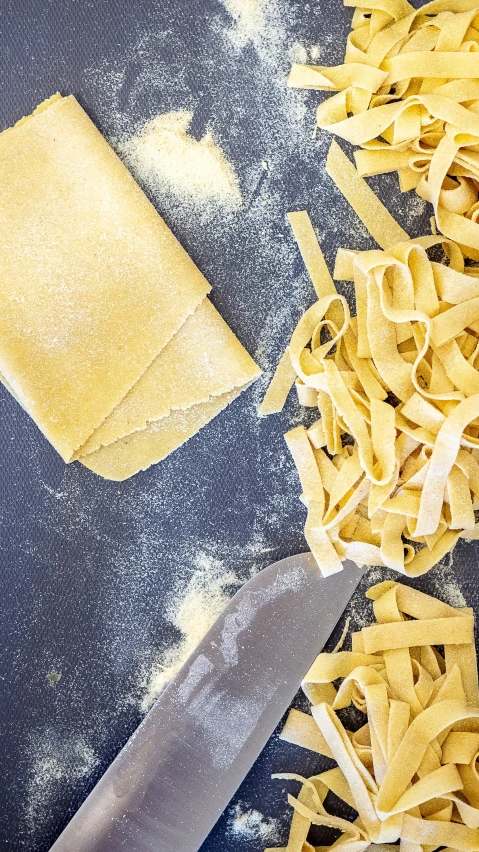 a knife next to noodles and other items