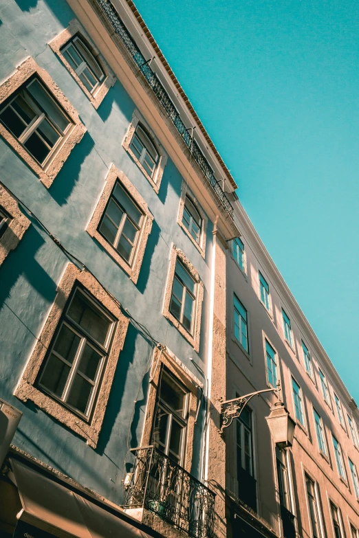 a blue building and several windows against a blue sky