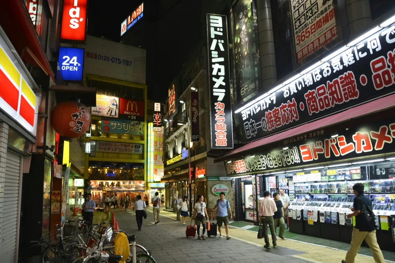 the people are walking in the city at night