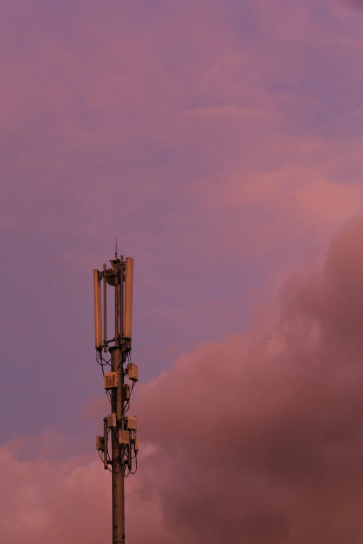 an antenna sits against the evening sky