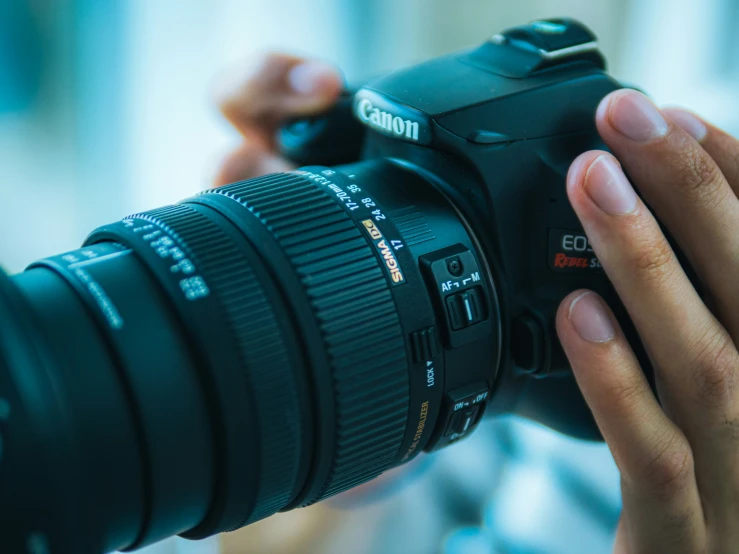 a man holding up his camera while he takes pictures