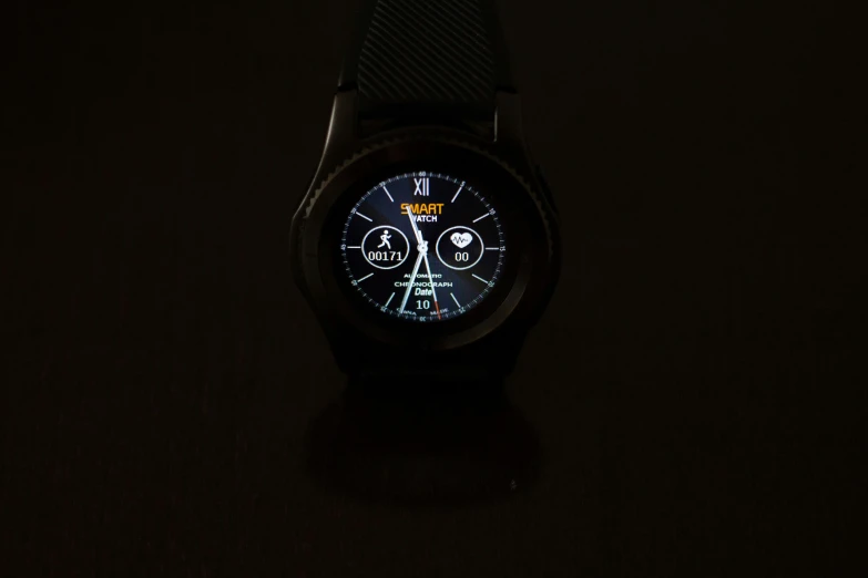 an illuminated watch face with dark background