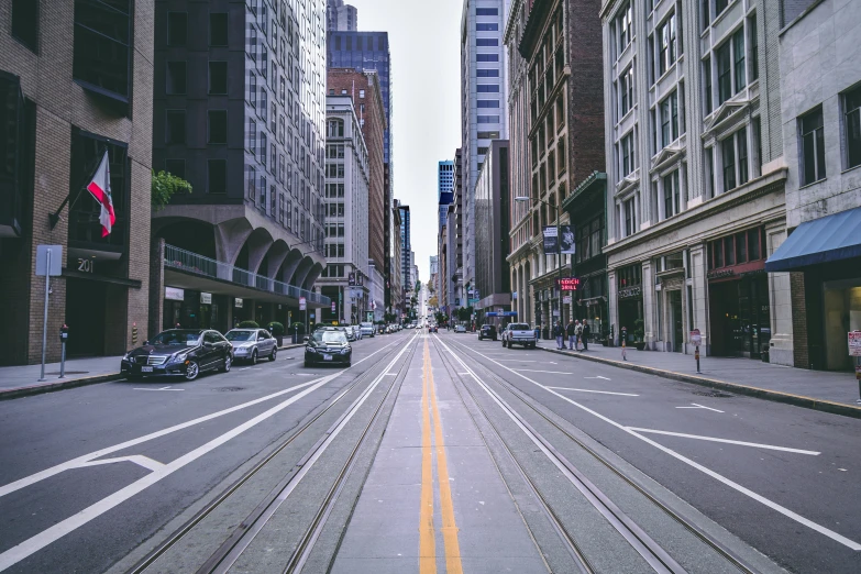 a deserted city street lined with tall buildings