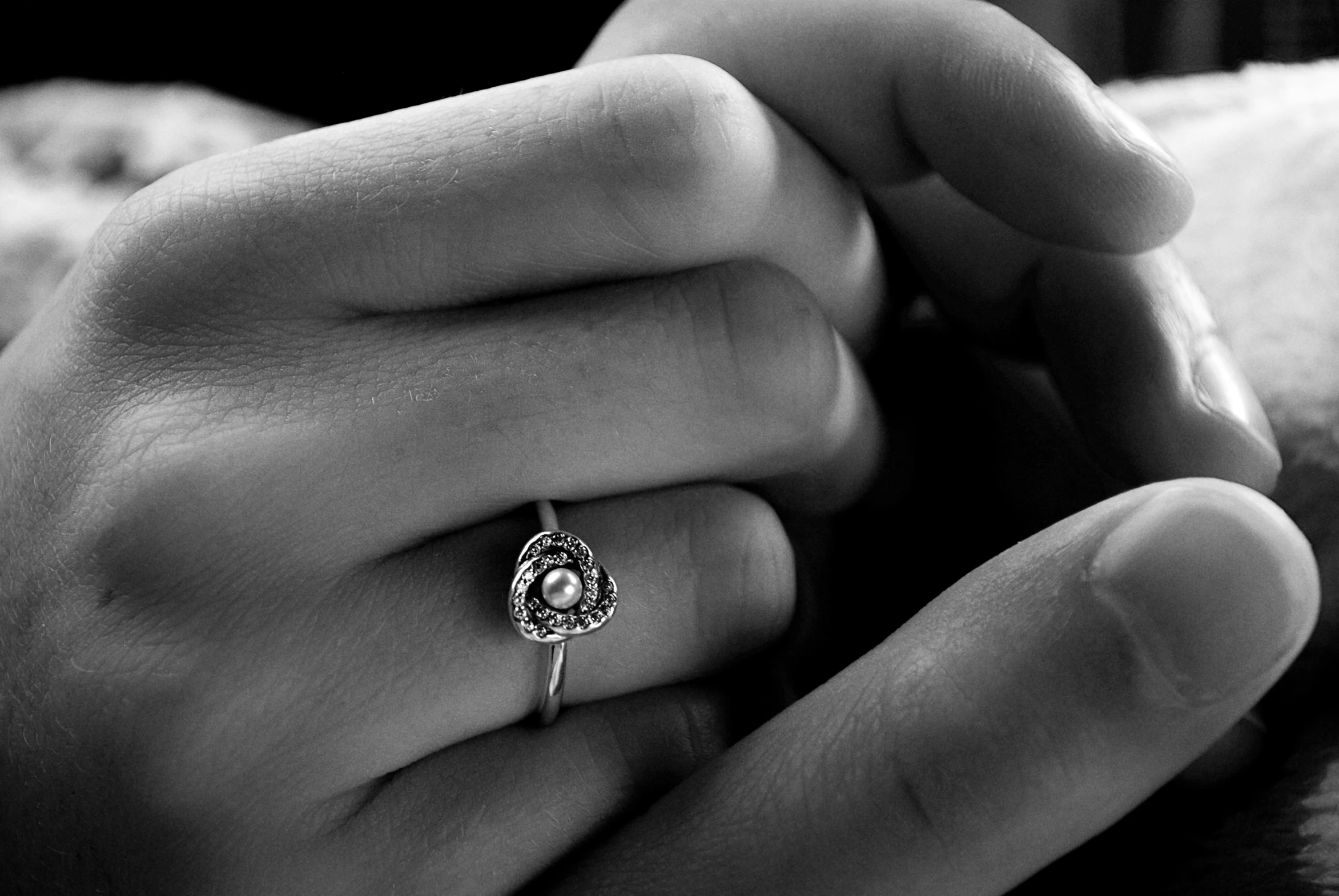 a woman is holding her hand with an engagement ring