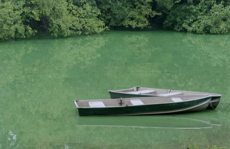 two boats are in the water next to each other