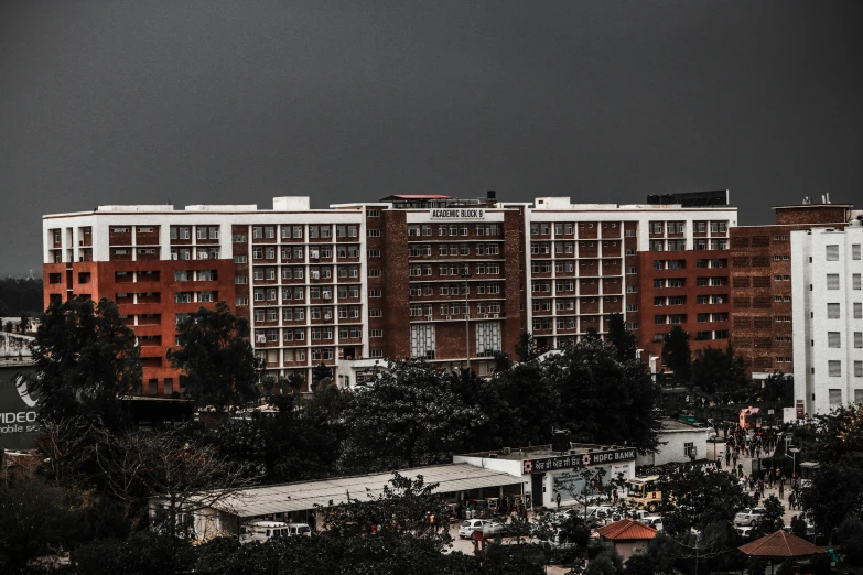 dark skies over apartment buildings and trees