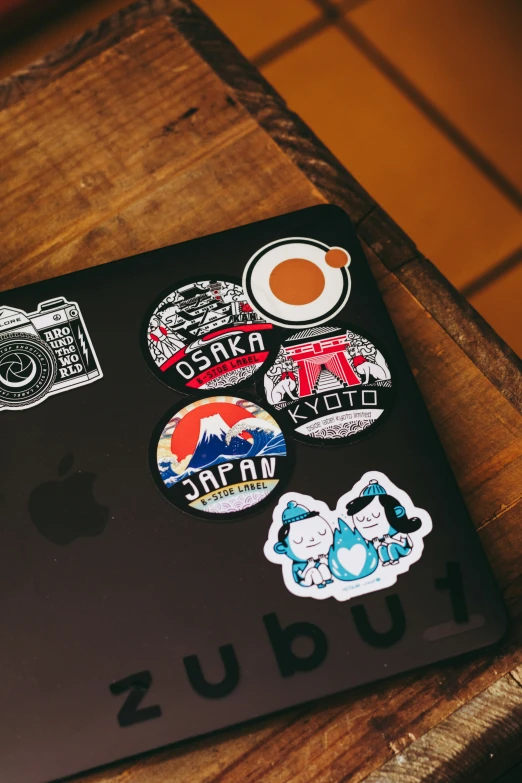 several different stickers sitting on a laptop keyboard