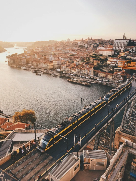 a train on tracks that is beside a body of water