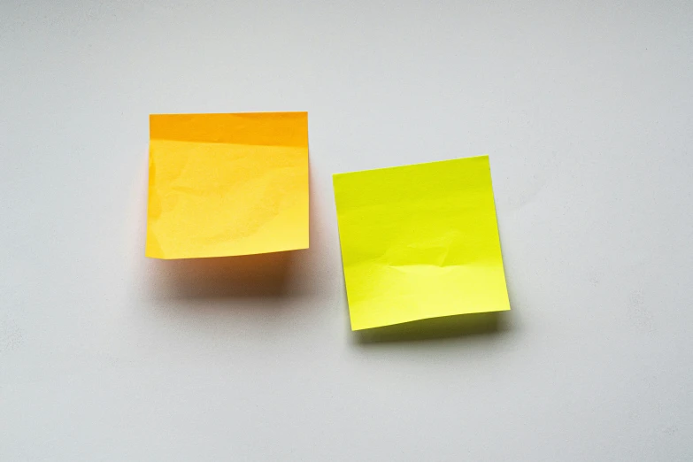 yellow and orange colored pieces of paper with some reflection