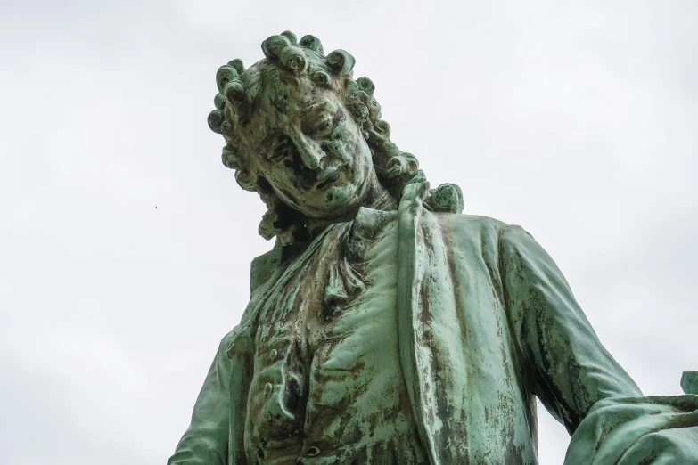 a statue of a man wearing a white shirt and holding a frisbee