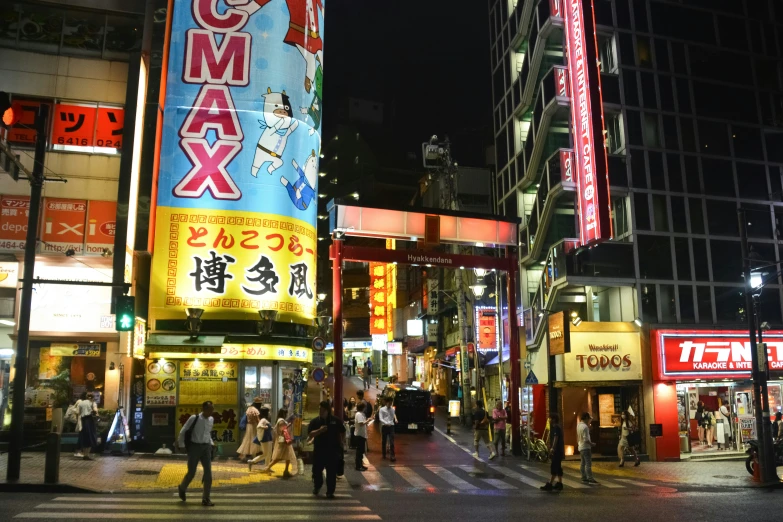 some tall buildings and people walking in the street