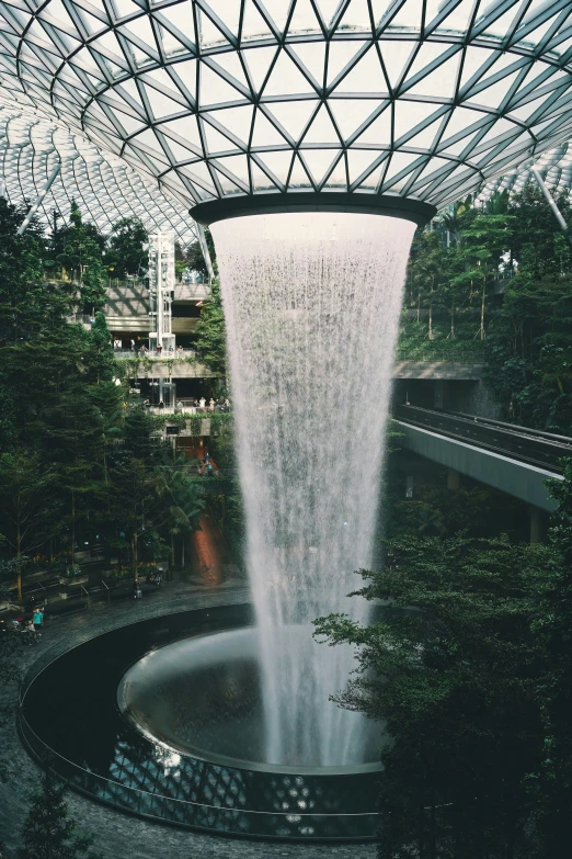 a waterfall on the edge of a fountain at a shopping mall