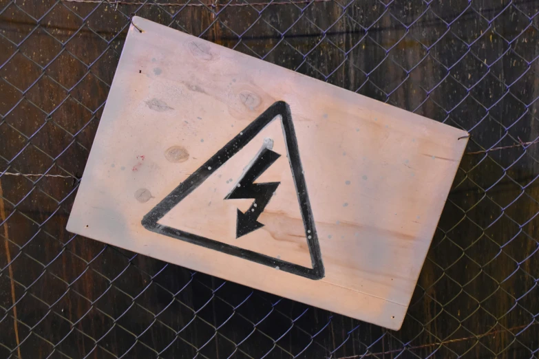 an image of a warning sign attached to a chain link fence