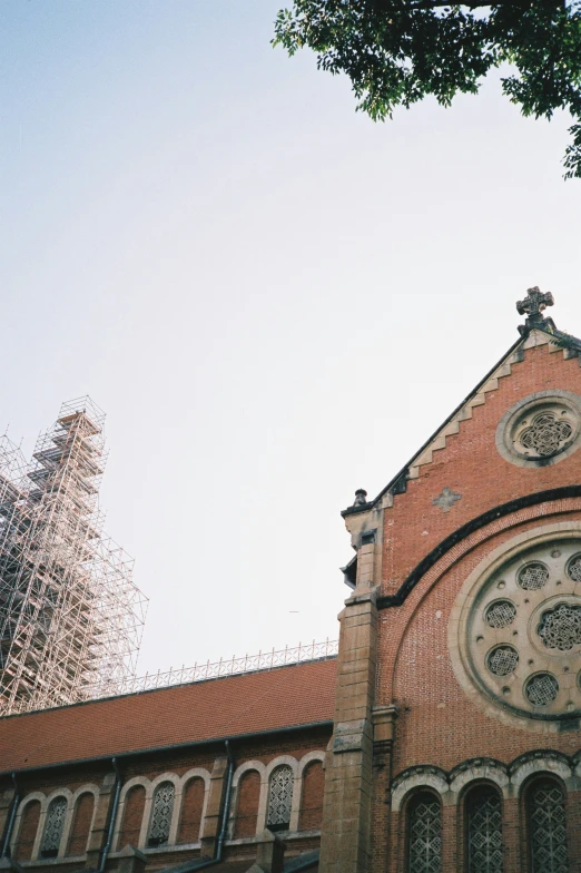 looking up at a church and an orange brick building