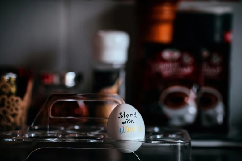 an egg sitting on top of a counter next to liquor