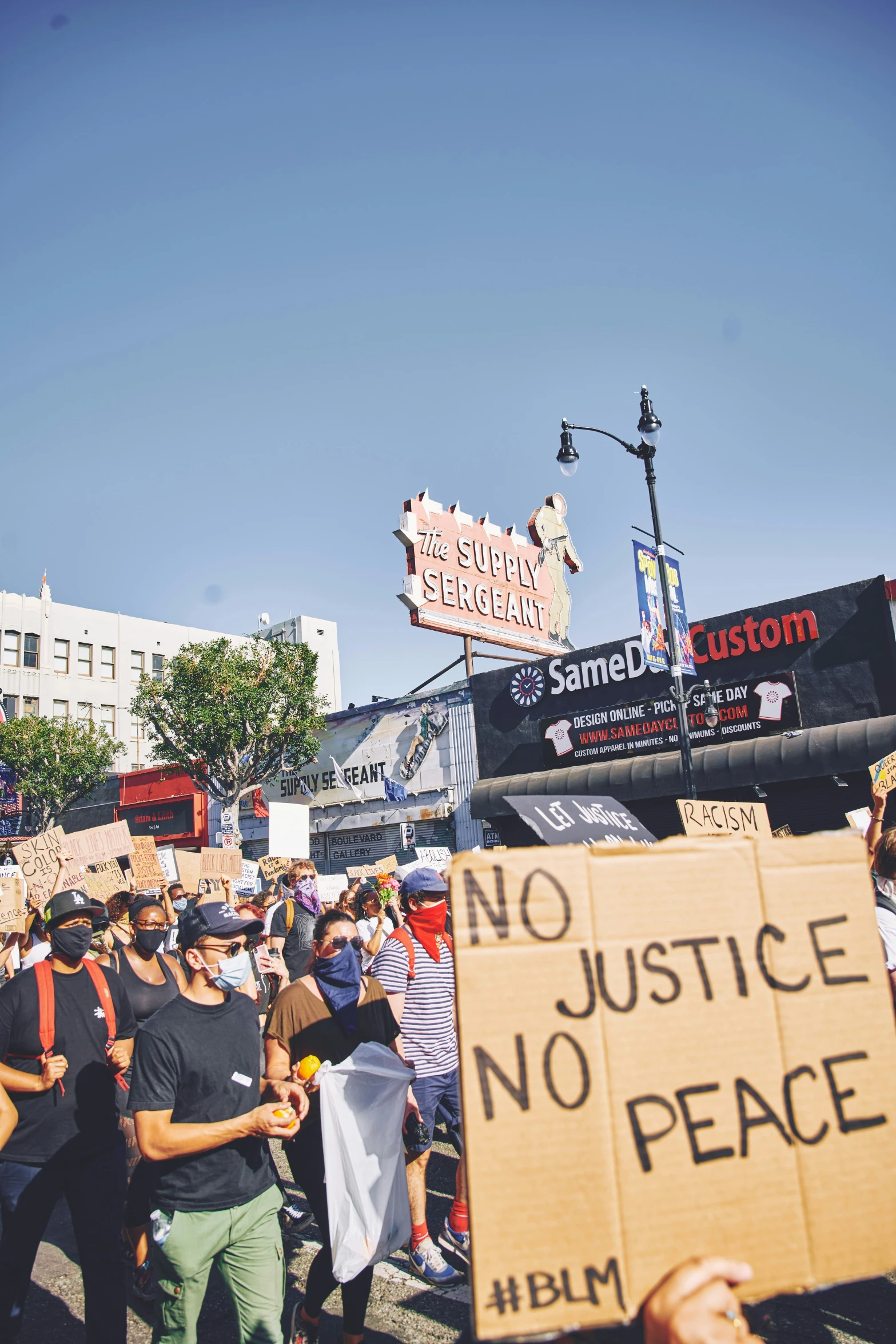 some people holding signs and placards near a building