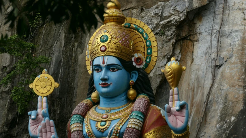 a statue of the god rama holding a gold coin