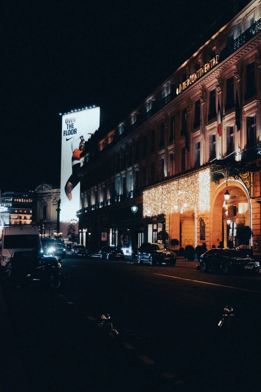 the building is lit up in christmas colors