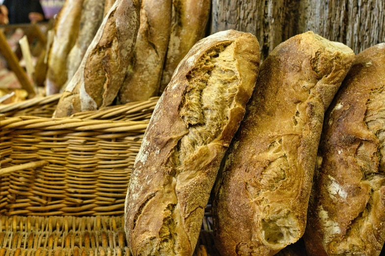 a bunch of bread in a basket near a pole