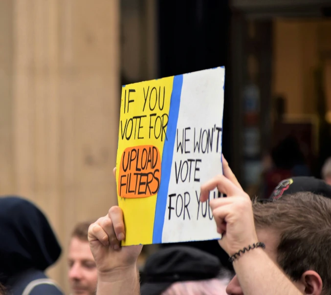 a group of people standing around with protest signs