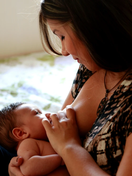 an adult woman holding a baby in her arms