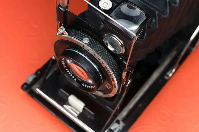 an old fashioned camera has a lens attached to it