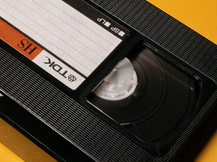an old - fashioned tape recorder is shown with a orange line