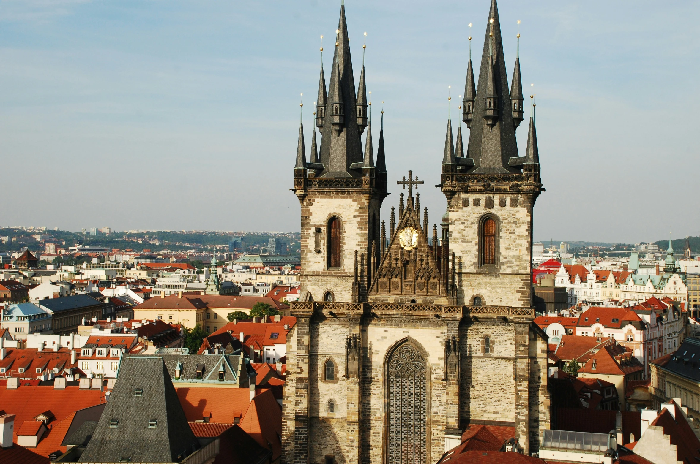 an old building with towers that are in the middle of some buildings