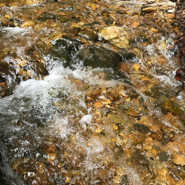 the water is flowing down into the rocks