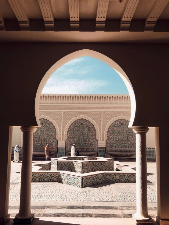 the arches are open and the fountain is surrounded by a circular walkway with two statues in front