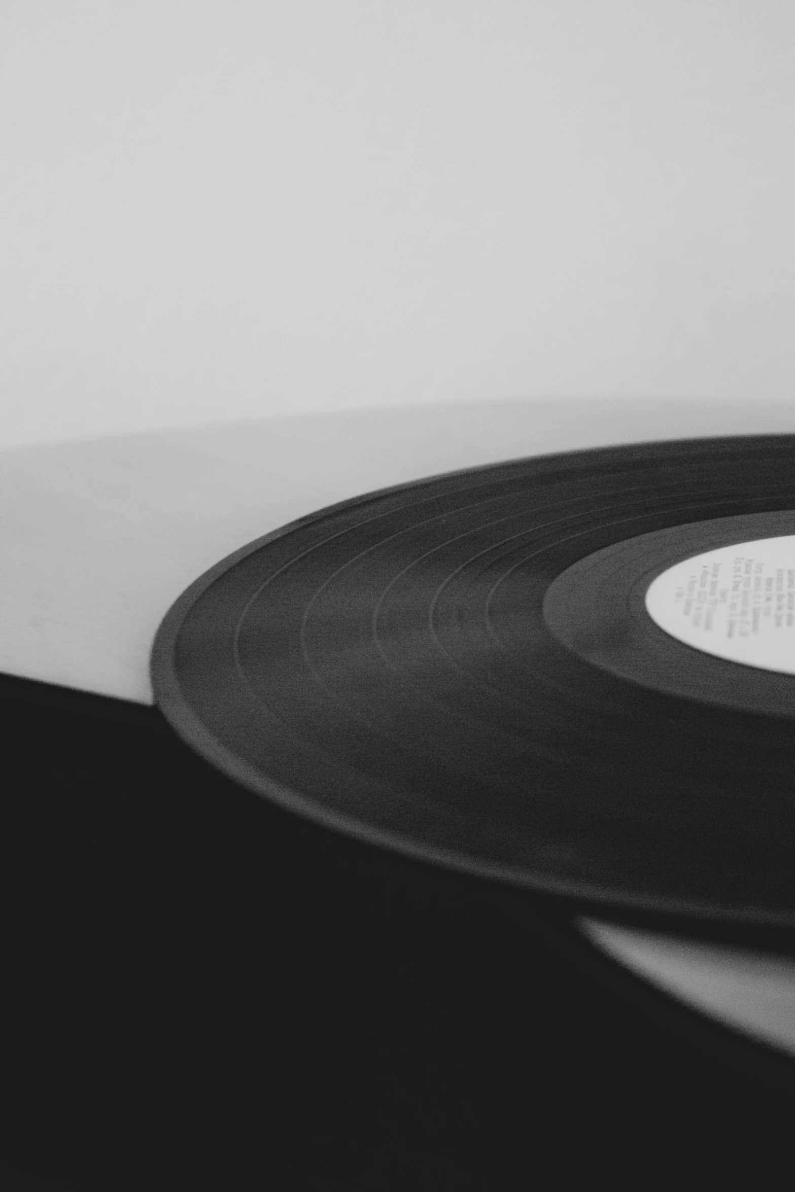 a black vinyl record with a white circle