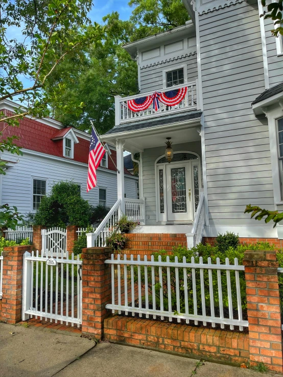 an american flag hanging on a front porch