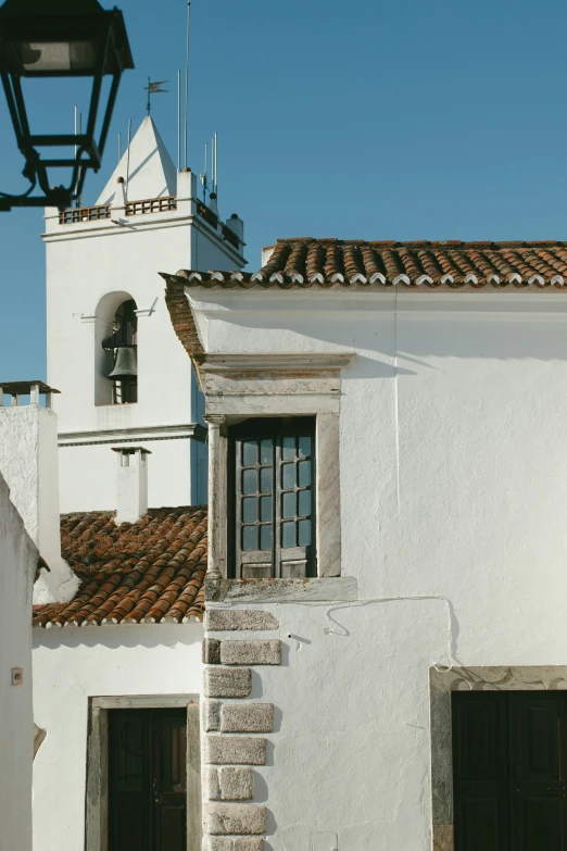 the window of an old spanish - style building is broken open