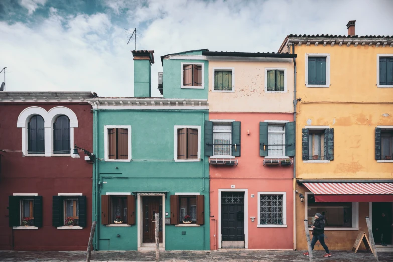 a row of colorful houses with two men walking outside