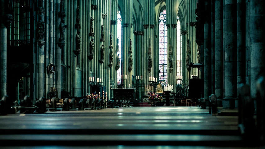 the inside of a church with pews, stained glass windows and a floor in front