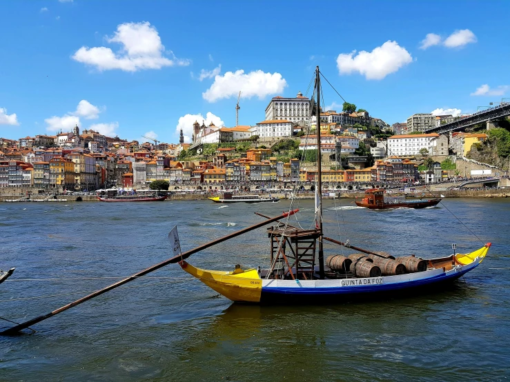 a small boat with two people in it floating on the water