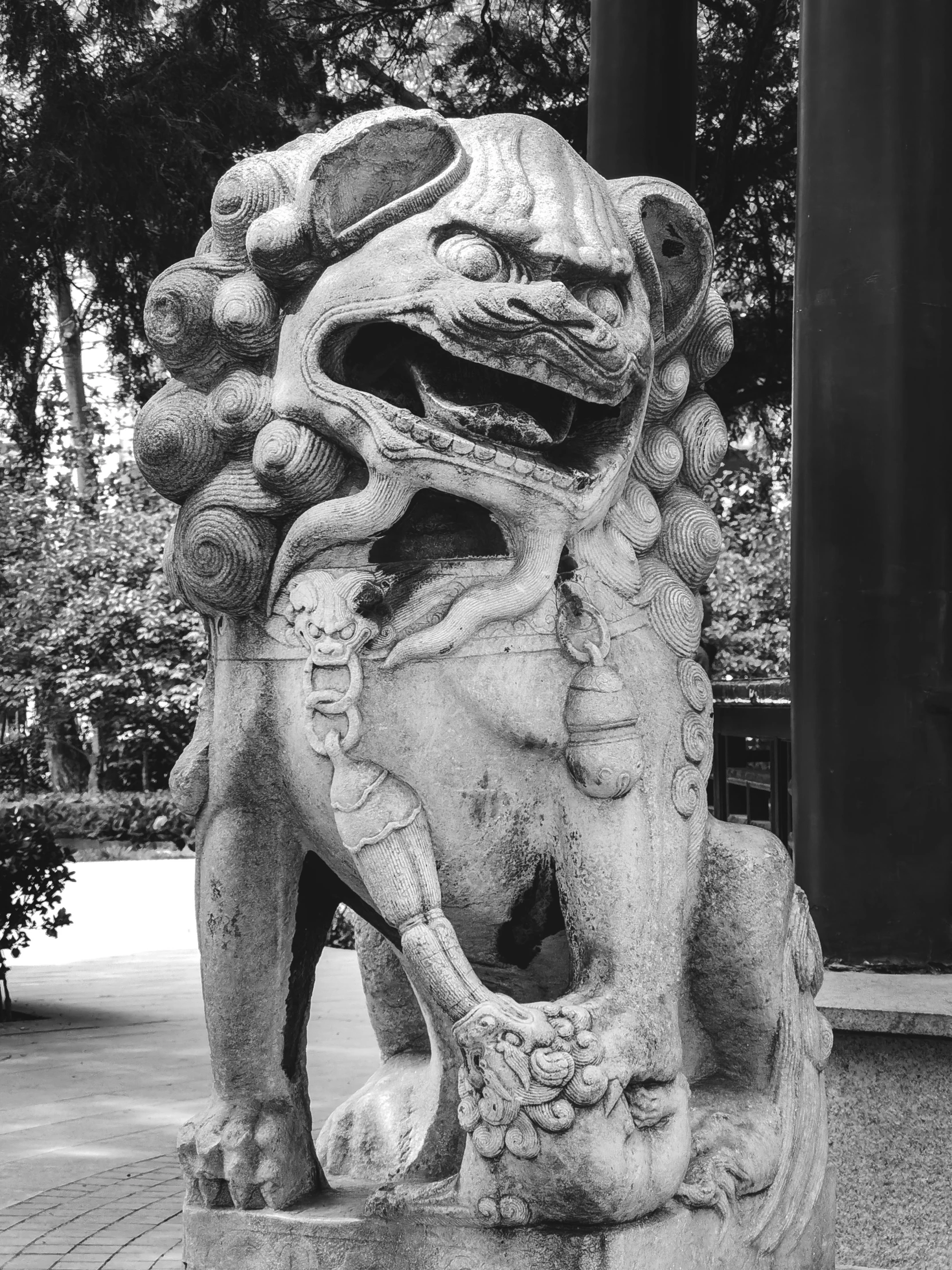 a statue of a lion on a brick walkway