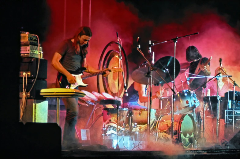 a concert with a band and drum set on stage