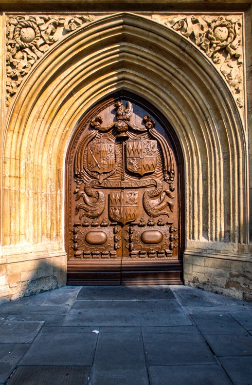 an ornate door on a stone building, showing a coat of arms