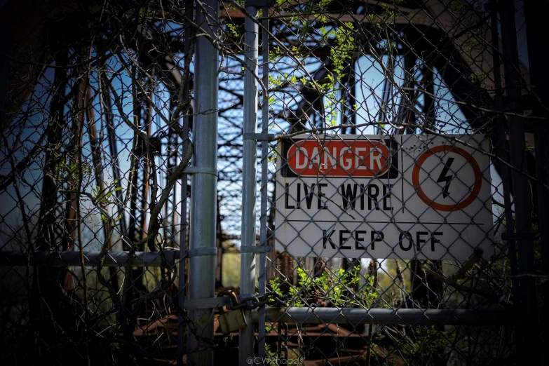 a fence with a sign saying danger live wire