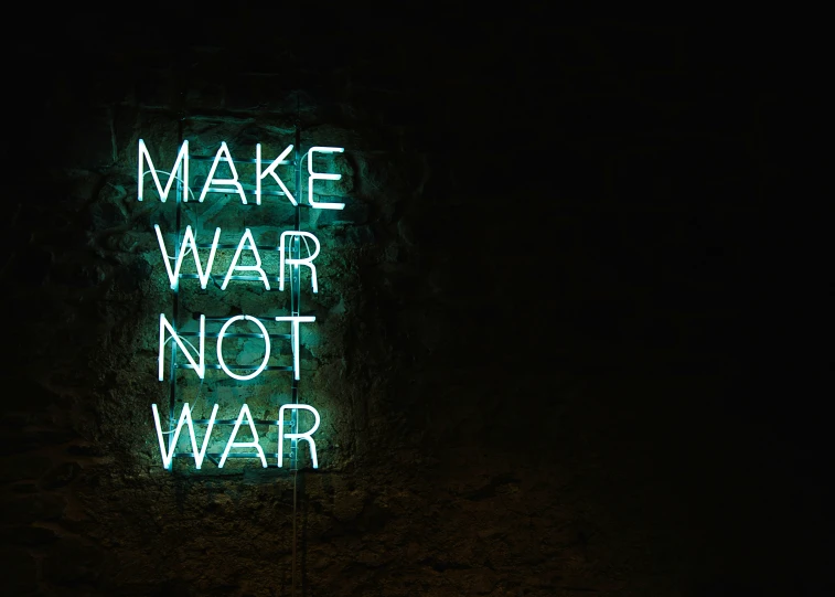a sign in the dark says make war not war