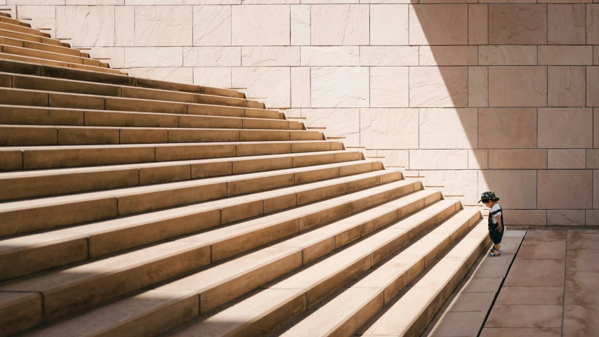 a young child is walking up some stairs