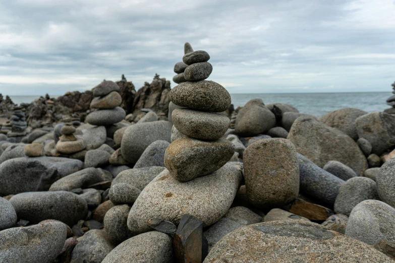 rock piles and stacked rocks on a beach